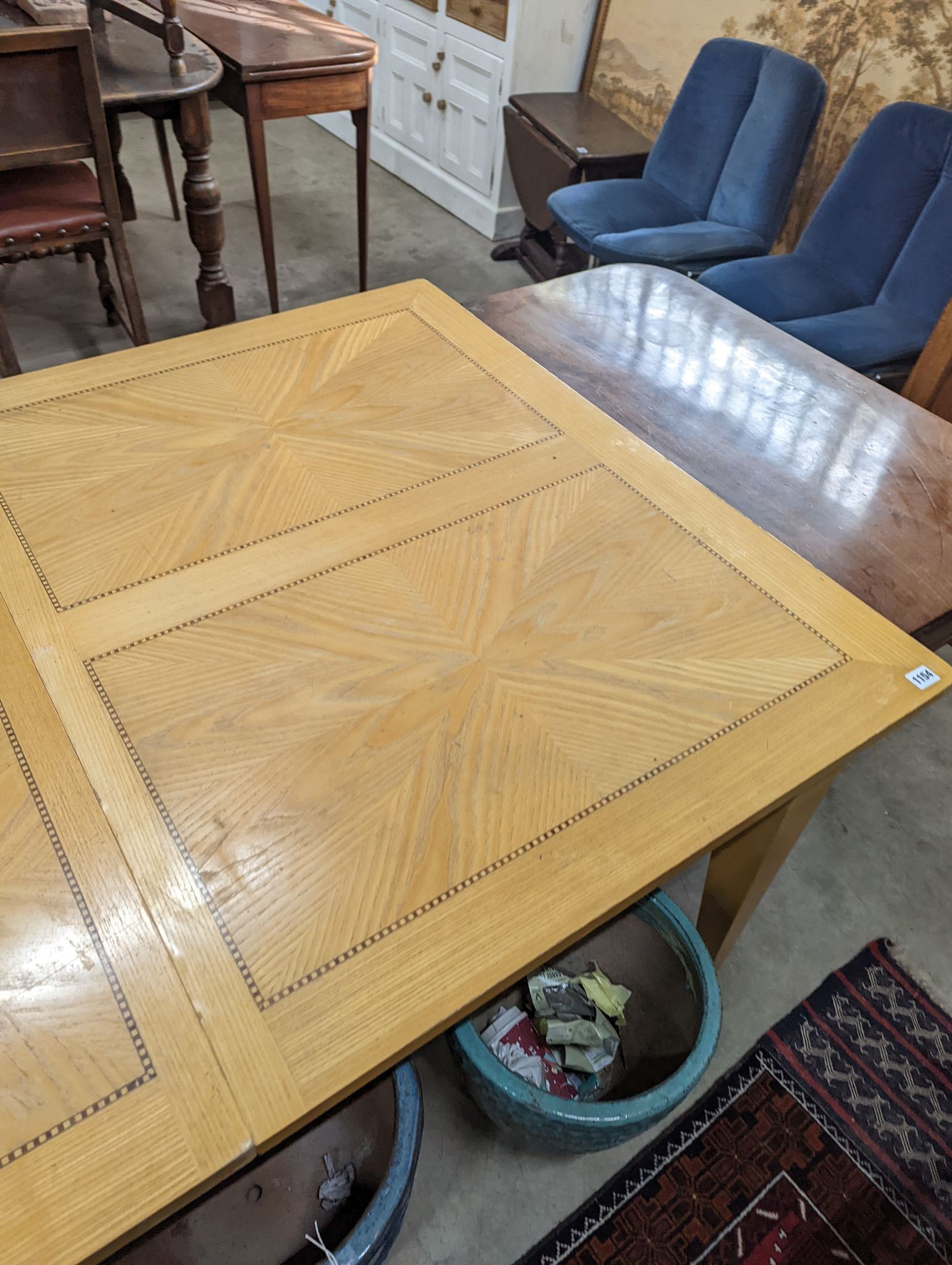 A contemporary inlaid oak extending dining table, 237cm extended, width 107cm, height 75cm